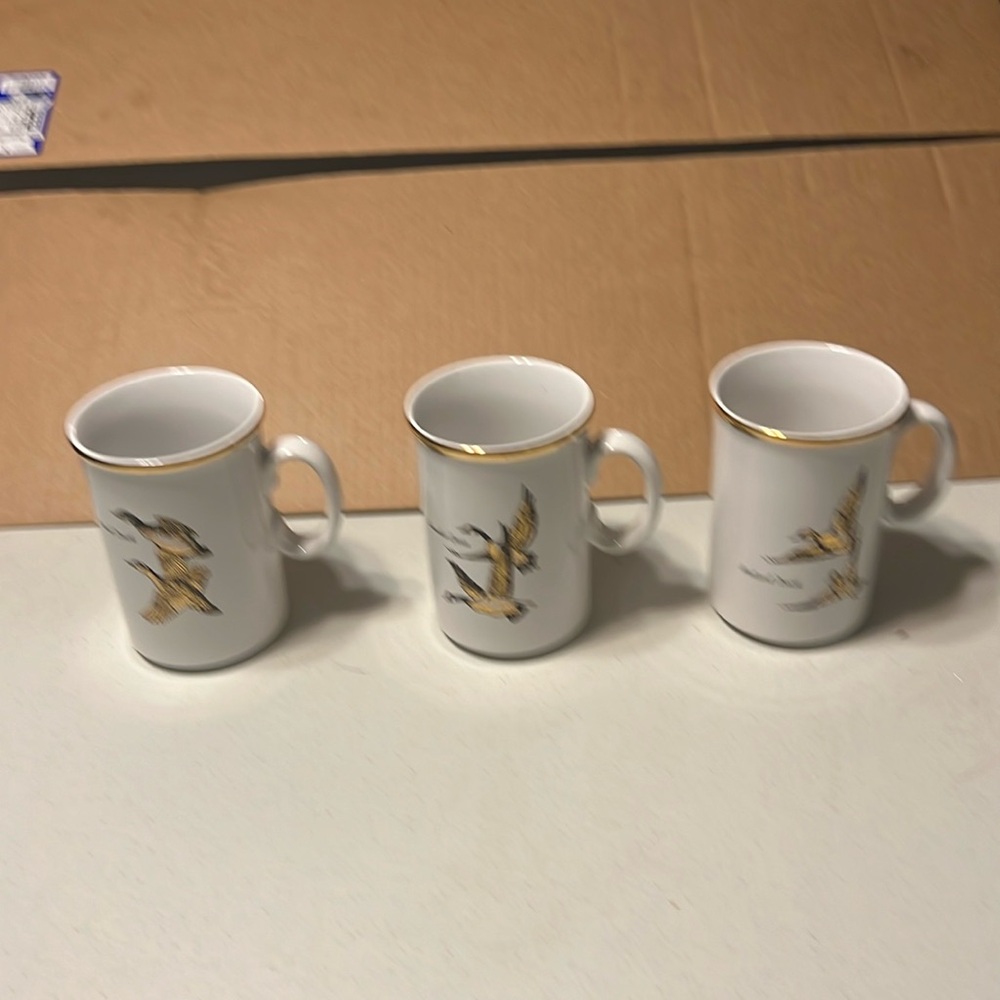 3 made in holland coffee mugs with gold design.